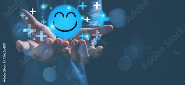Fototapeta Mental health positive thinking and growth mindset. Hands holding blue happy smile face icon good feedback rating, positive customer review, experience, satisfaction survey, smiley mental health.
