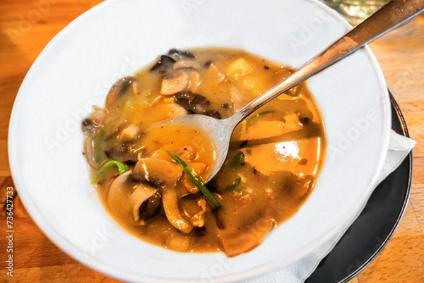 Fototapeta Mushroom soup with potato in white plate.