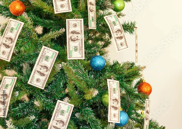 Fototapeta Christmas tree decorated with dollars notes