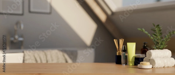 Obraz A display space on a hardwood table with bath accessories in a modern bright and clean bathroom.