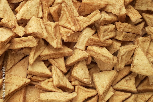 Fototapeta Fried tofu, a snack or cooking ingredient, ingredients from fried tofu, come in triangular and rectangular shapes