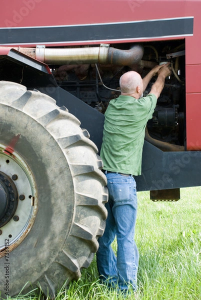 Obraz Man changing oil filter on large engine