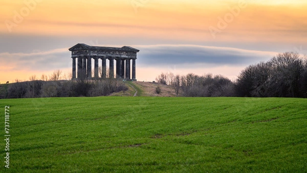 Fototapeta Sunset at Penshaw Monument.  Penshaw Monument is a smaller copy of the Greek Temple of Hephaestus in Athens. Erected in 1844 the folly stands 20 metres high and dominates the skyline of Wearside