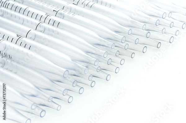 Obraz plastic pipette in a row isolated on white