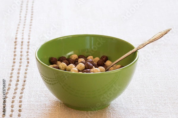 Fototapeta Green bowl with cereals and a spoon in it