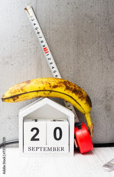 Obraz Weight loss concept, banana with meter for measuring waist. Banana with tape measure