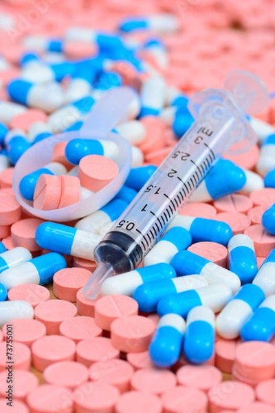 Fototapeta syringe with  spoon on many  pills and capsules