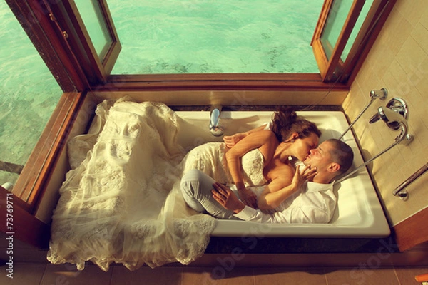 Obraz Bride and groom in bath tub in Maldives