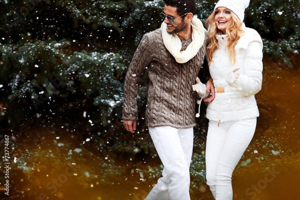 Fototapeta Happy couple near a Christmas tree. Christmas Eve.