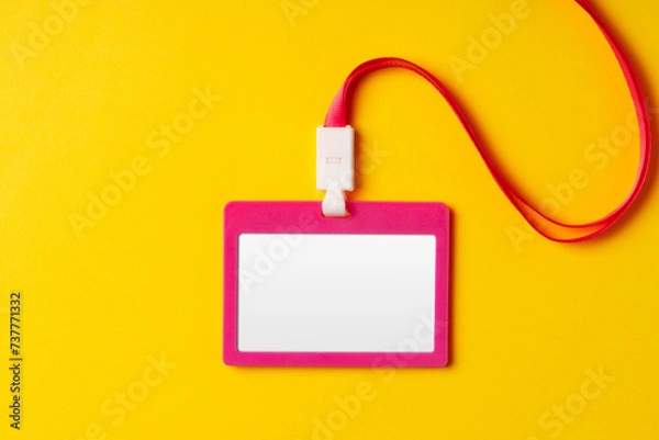 Fototapeta Blank nametag on a string on yellow background copy space