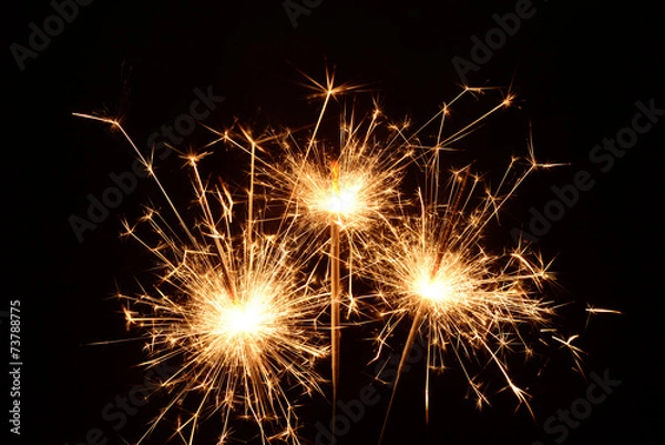 Fototapeta Three burning christmas sparklers
