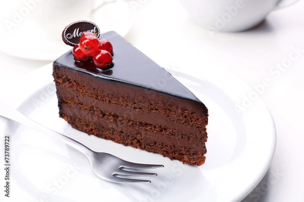 Fototapeta Delicious chocolate cake on plate on table on light background