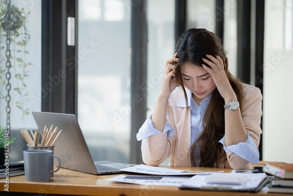 Fototapeta Asian businesswoman are stressed and tired from work at desk in the office, feeling sick at work, stress from work.