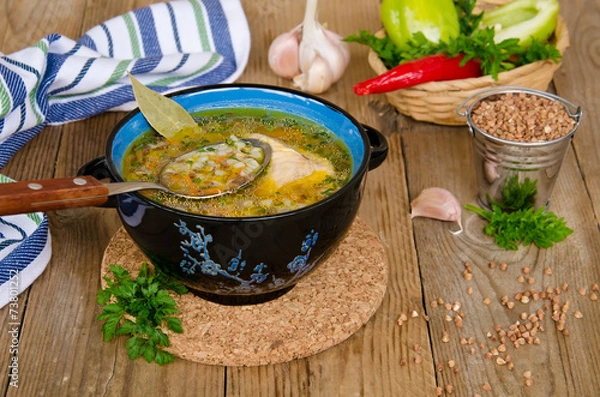 Fototapeta Soup with buckwheat groats on a wooden background