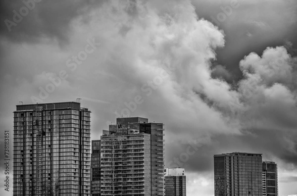 Fototapeta Close Together Skyscrapers Under Overcast Sky in Black and White.