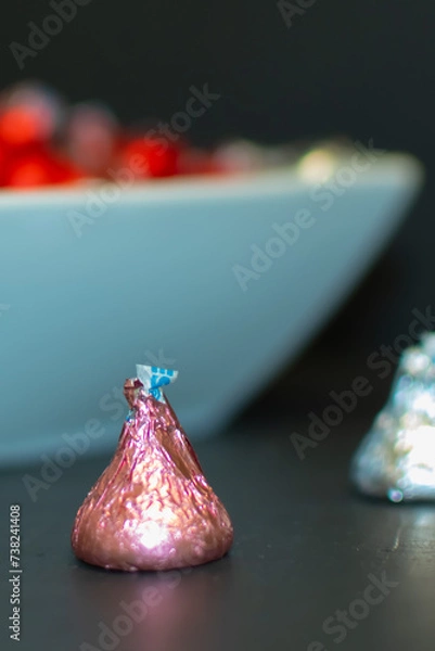 Fototapeta A close up of a piece of candy wrapped in pink foil. 