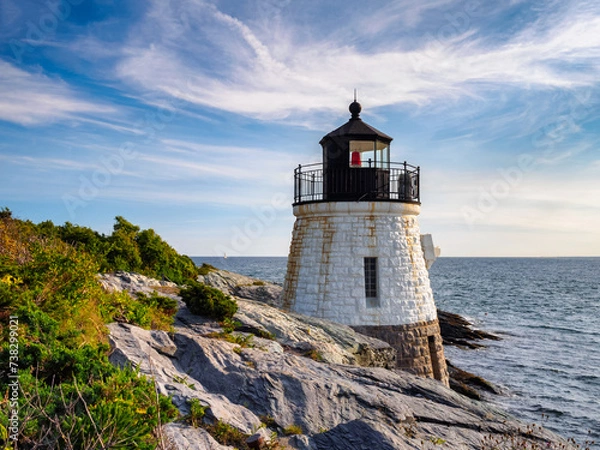 Fototapeta Castle Hill Lighthouse in summer overlooking Narragansett Bay,  Newport Rhode Island, a beautiful  scenic New England landscape. The 1890 light house is built right into the cliff.