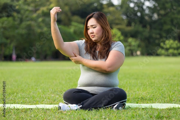 Obraz obese women is worrying about her overweight