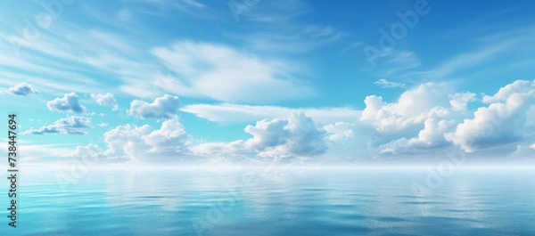 Fototapeta Sky and clouds over water on a blue horizont