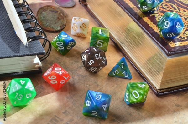 Obraz Dice for playing dnd, rpg, fantasy games. twenty-sided cube and polyhedral cubes .Close up of spilling out dice of different kinds , book, pencil..