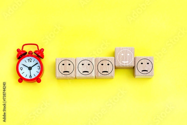 Fototapeta alarm clock,  cubes with person icons on the background.