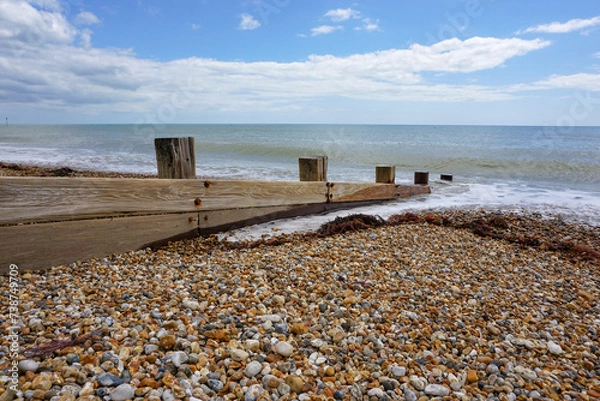 Fototapeta Coastal view looking out to sea from traditional English beach. Stone pebble beach landscape 