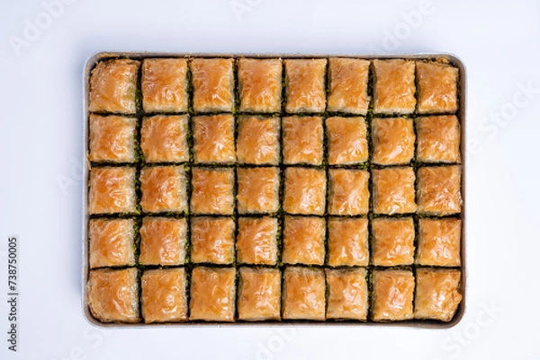 Fototapeta Top view of pistachio baklava on a tray isolated on white background.