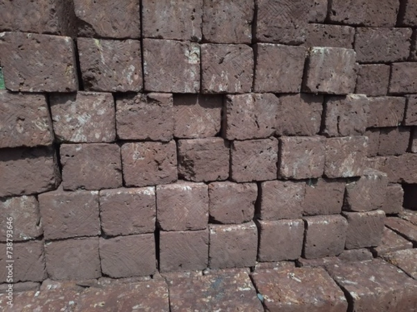 Obraz A stack of laterite stone neatly arranged, side by side, forming a sturdy foundation or a potential construction project.