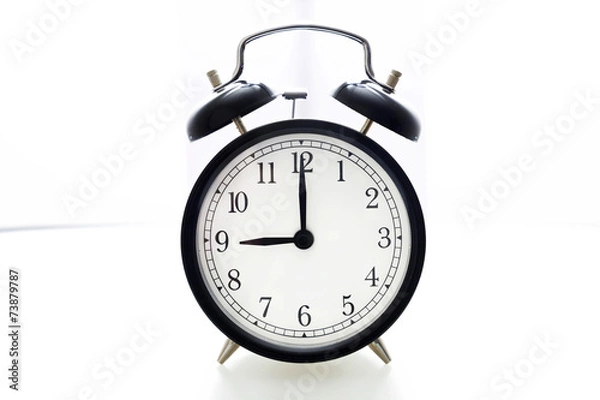 Fototapeta Oldfashioned black glossy alarm clock showing 8 o'clock