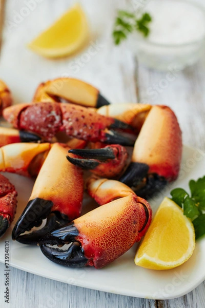 Fototapeta Boiled crab claws with lemon