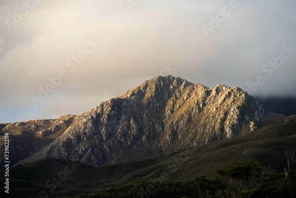 Fototapeta Beautiful Rocky Mountain over a lake in a beautiful park. Wilderness landscape with no people. Stunning bush and forest by the sea and ocean.