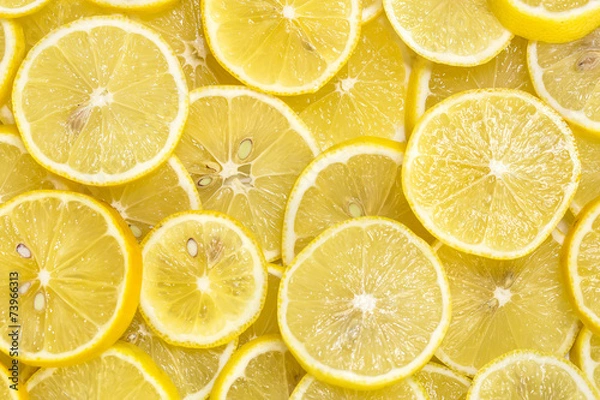 Fototapeta background of sliced ripe lemons