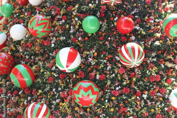 Fototapeta Large colorful decorations on a large Christmas tree. 