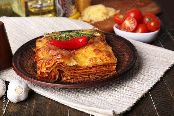 Fototapeta Portion of tasty lasagna on table