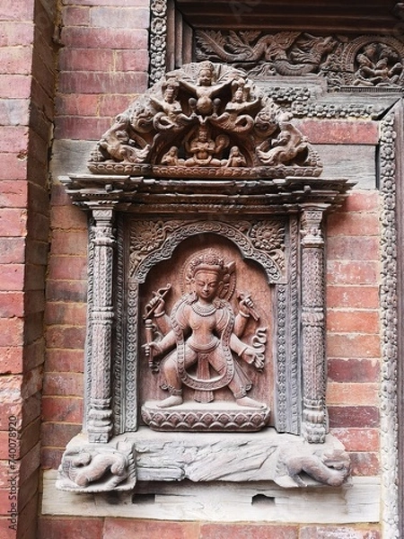 Fototapeta Divine Artistry: A Wooden Carving of a Deity at Mul Chowk Courtyard, Patan Darbar Square, Nepal