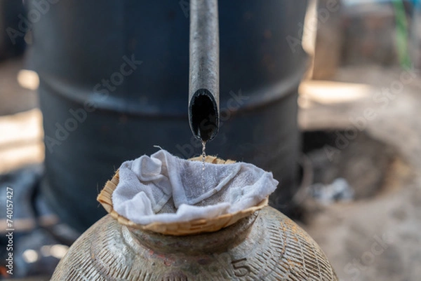 Fototapeta Distillation of Laos Whisky in a village near Luang Prabang, Laos, South-East Asia