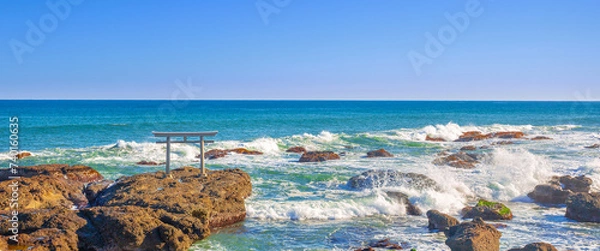 Fototapeta Panorama view one of the tourist attraction in Japan, Torii gates of Oarai Isosaki-jinja by the sea in bright blue sky day