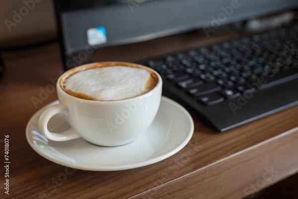 Obraz Coffee cup and computer on table