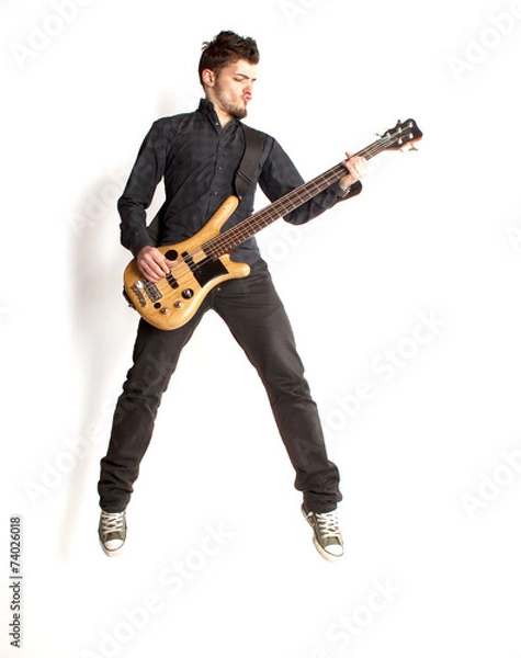 Fototapeta Jumping bass player on a white background