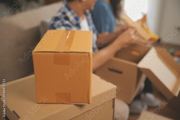 Fototapeta Two Asian blogger showing clothes in front of the camera to recording vlog video live streaming at her shop. Online Shopping Cart notion. on sofa at home