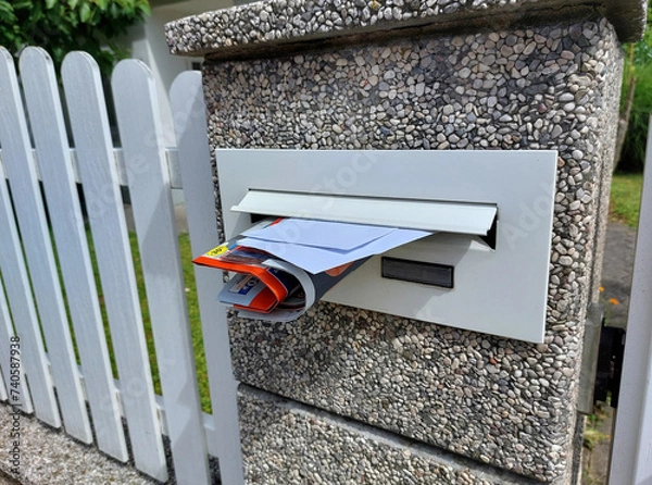 Fototapeta white mailbox with letters and advertise on fence