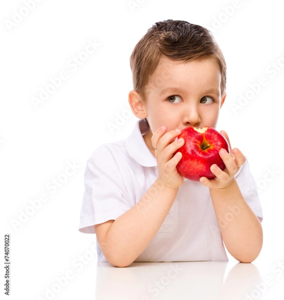 Fototapeta Cute boy with red apples