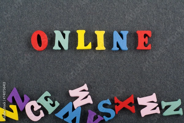 Fototapeta ONLINE word on black board background composed from colorful abc alphabet block wooden letters, copy space for ad text. Learning english concept.