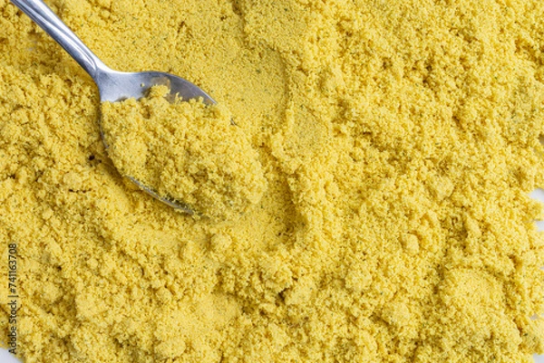 Fototapeta An abstract image of powdered chicken soup stock mixed with spices and metal spoon. 