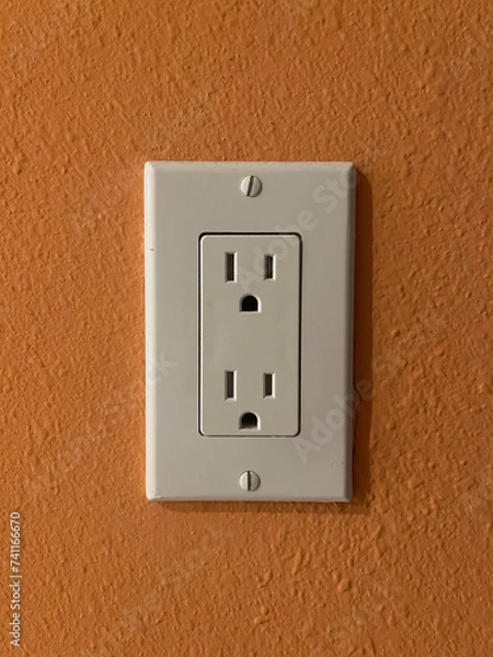 Fototapeta Electrical outlet on orange wall