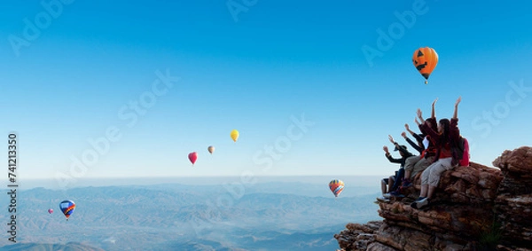 Fototapeta Group of happy hiker raised up arms on the top of mountain