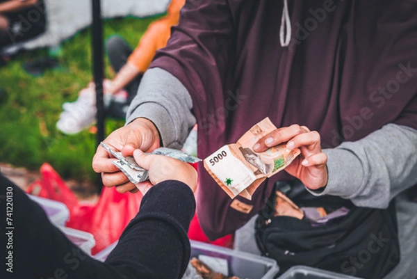 Obraz Illustration of Hands doing transaction on traditional market using Rupiah money