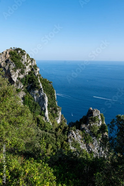 Fototapeta Sunny ocean shore with cliffs and forests
