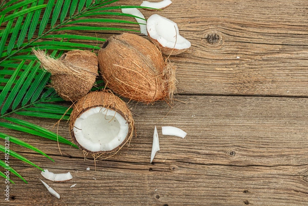 Fototapeta Summer tropical background with coconuts and palm leaves. Traditional decor, textured fruit, voyage