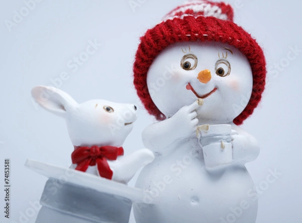 Fototapeta Cheerful snowman shows tricks